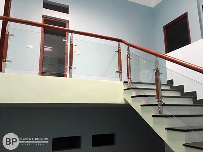 Cầu thang kính trụ inox tay vịn gỗ lắp đặt tại Hà Nam giá rẻ